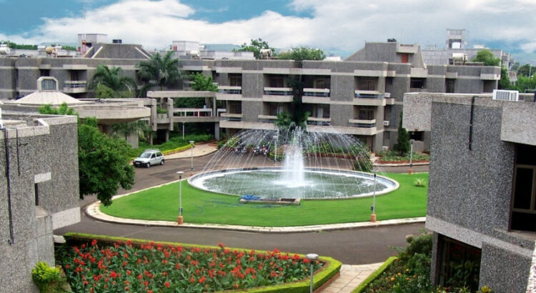 Campus view of the National Insurance Academy with a fountain in the center