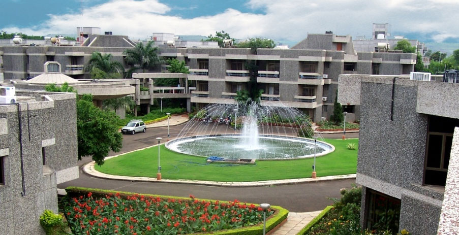 Campus view of the National Insurance Academy with a fountain in the center