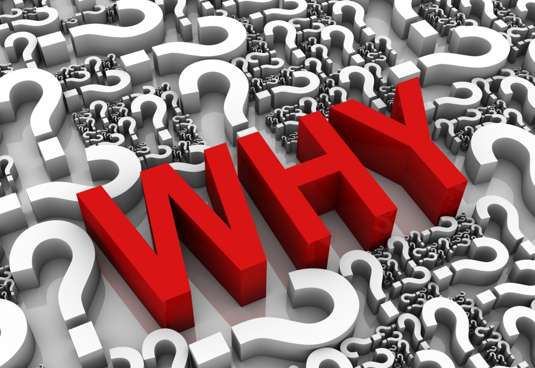 Red 3D word 'WHY' standing among gray question marks, conveying the concept of seeking why.