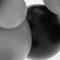 Abstract grayscale close-up of overlapping smooth, rounded shapes with brushed-metal texture.