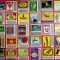 Grid of colorful vintage matchbox labels arranged in rows and columns, showcasing diverse logos and artwork.