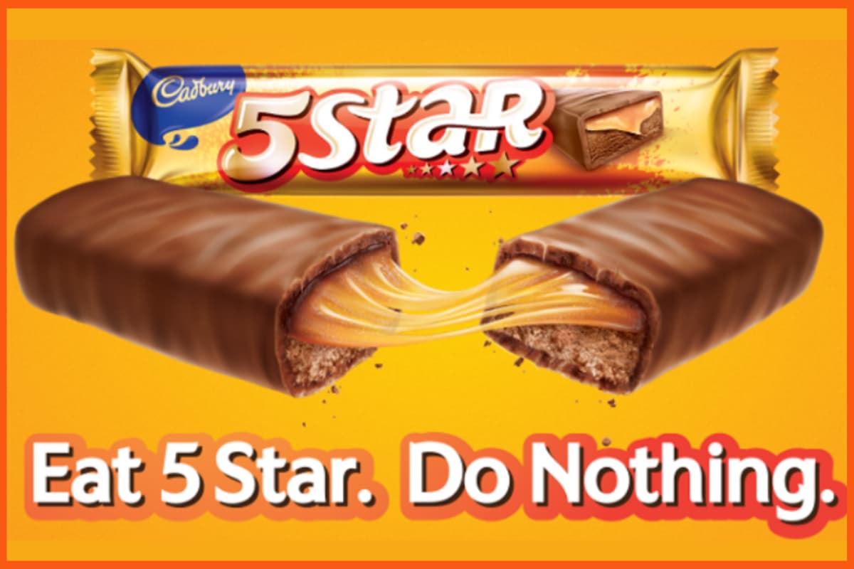 Cadbury 5 Star chocolate bar with caramel filling, split in half on an orange background with the slogan 'Eat 5 Star. Do Nothing.'