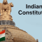 Dome of a monument with the Indian flag in the foreground and the words 'Indian Constitution' at the top right.