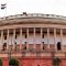 Indian Parliament building with a row of tall columns and the Indian flag on top]